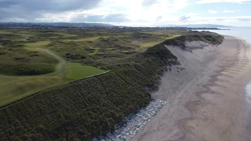 an aerial view of a golf course and sand dunes