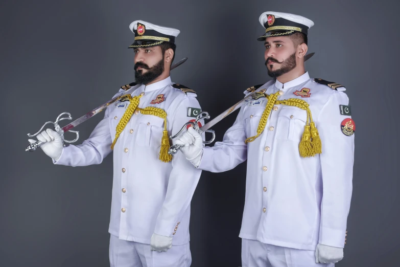 two naval personnel in uniforms hold two canes