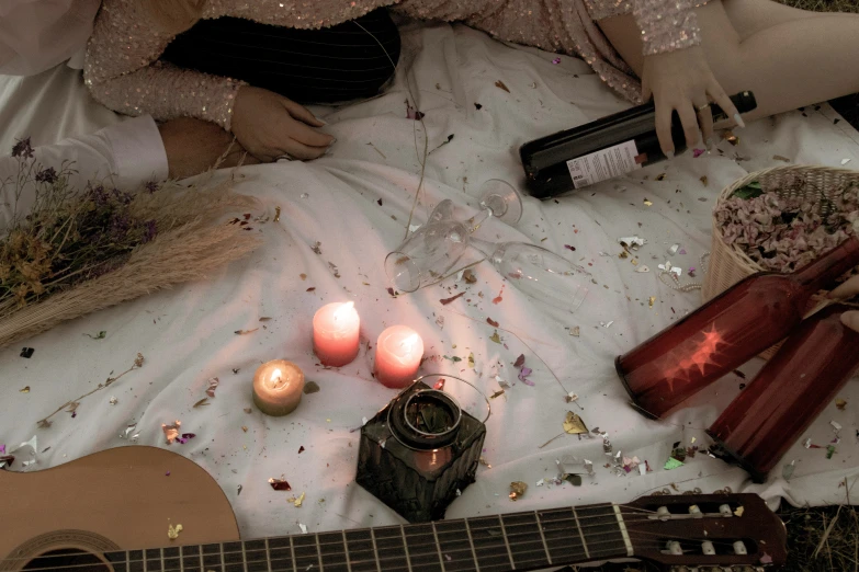 there is a guitar, candles and some other items on the bed