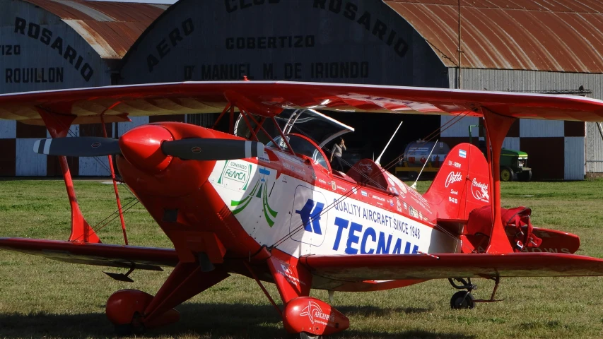 a small airplane is parked in front of a building