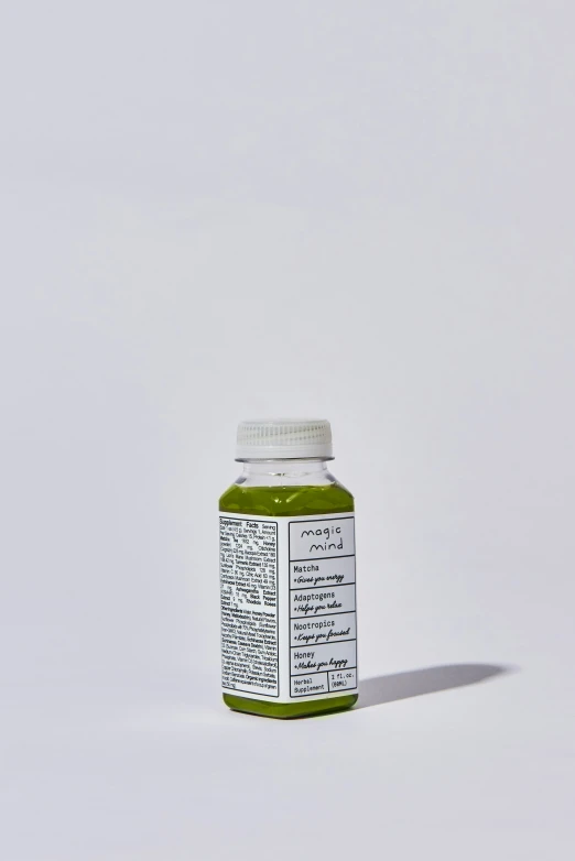 a bottle of green paint sitting on a table