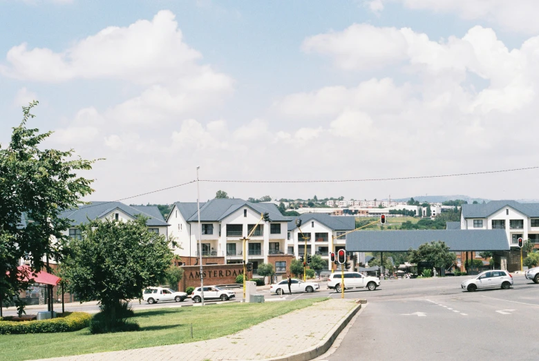 a city intersection with cars parked along it