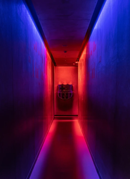 a long hallway with a dark colored light that matches the color of the room