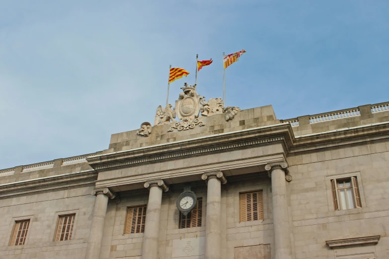 some flags that are on top of a building