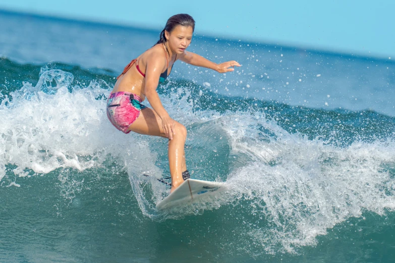 the  is riding on her surf board