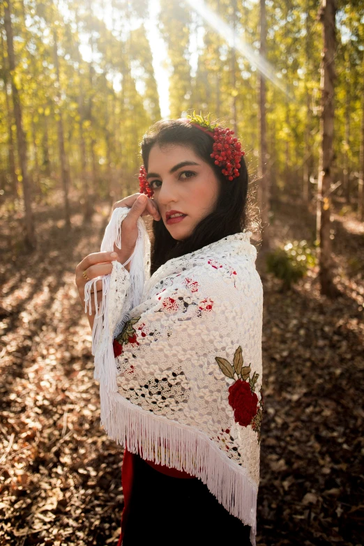 the woman in a shawl is holding her shawl