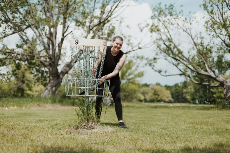 a man holding a shopping cart in the grass