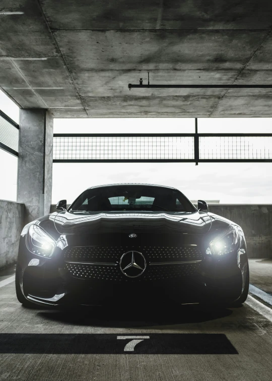 a mercedes sports car parked in an underground garage