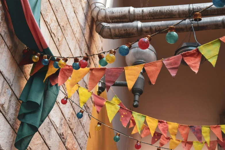 a multicolored triangle banner hanging from a wooden pole