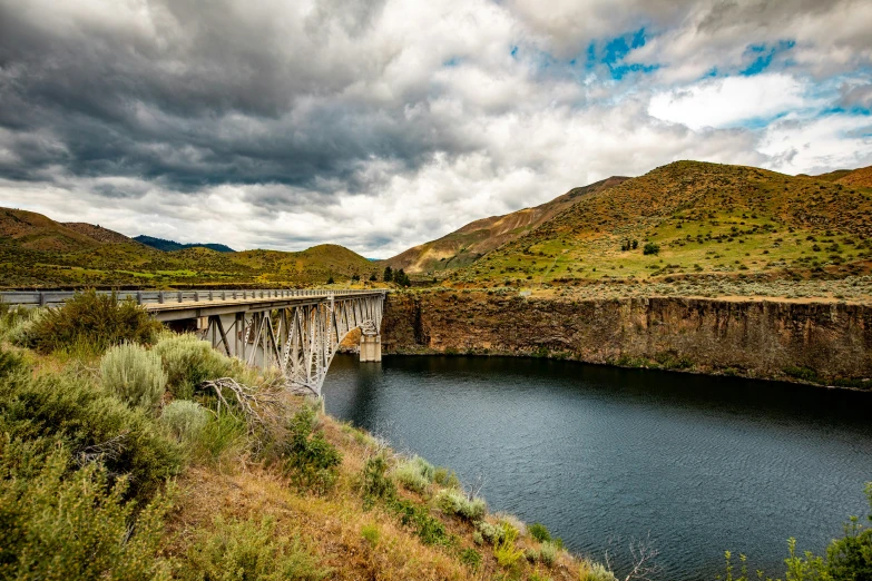 the view of an impressive river running beside a dam