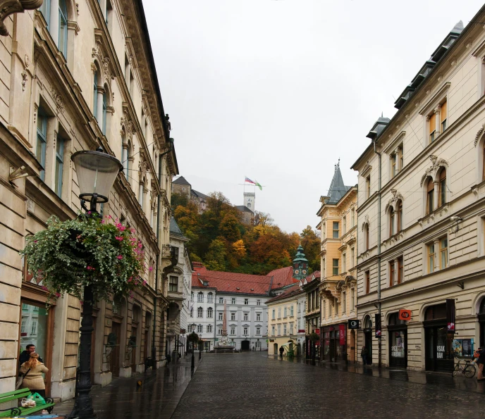 an empty street between some buildings next to a light pole