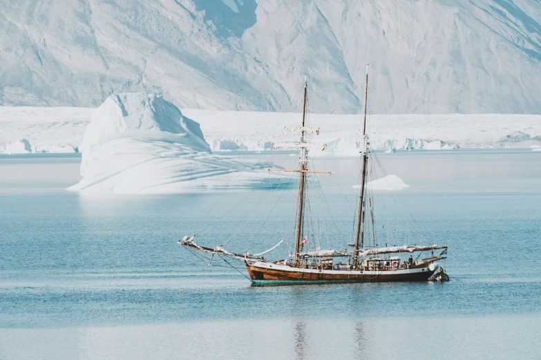 a large sail boat is in the middle of the water