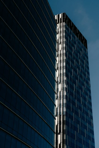 a tall glass office building with some windows