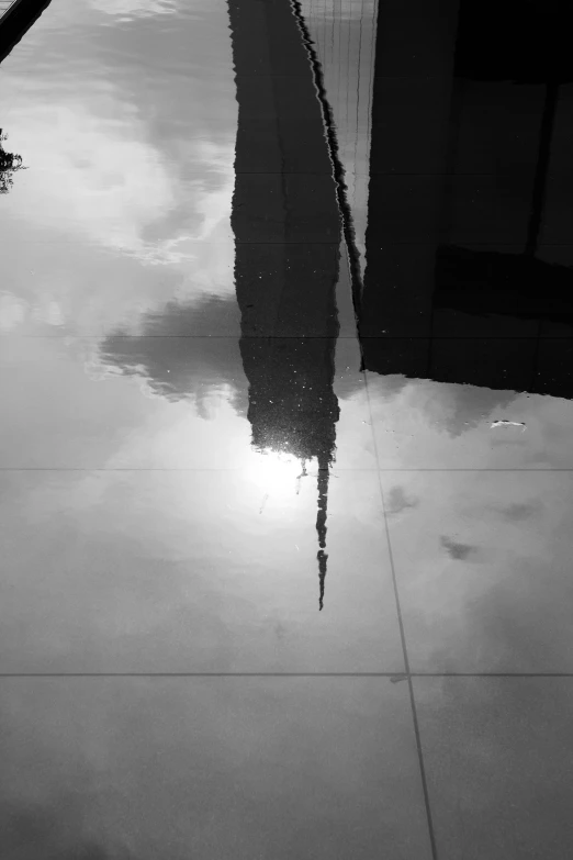 a large building with many reflections in the water