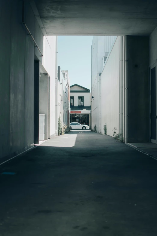 the empty street between two buildings in an open space