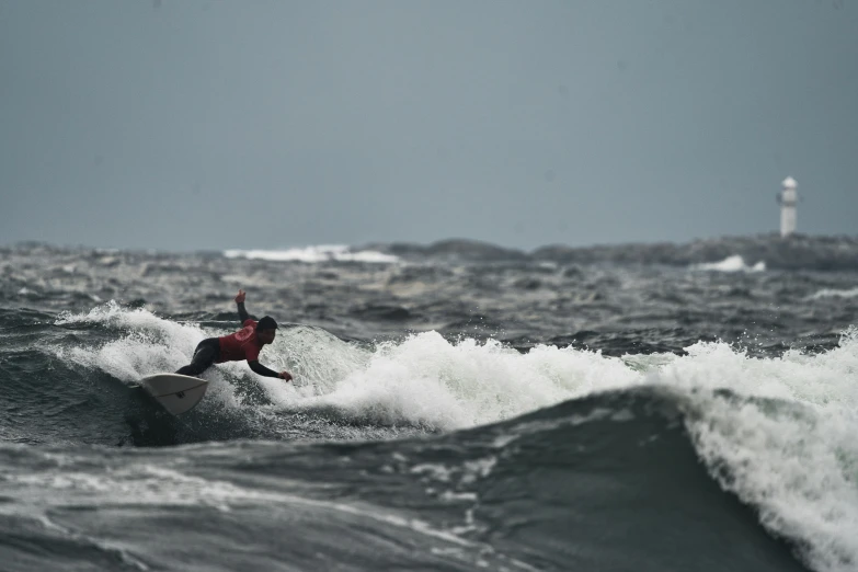 the surfer is riding his surfboard over a wave