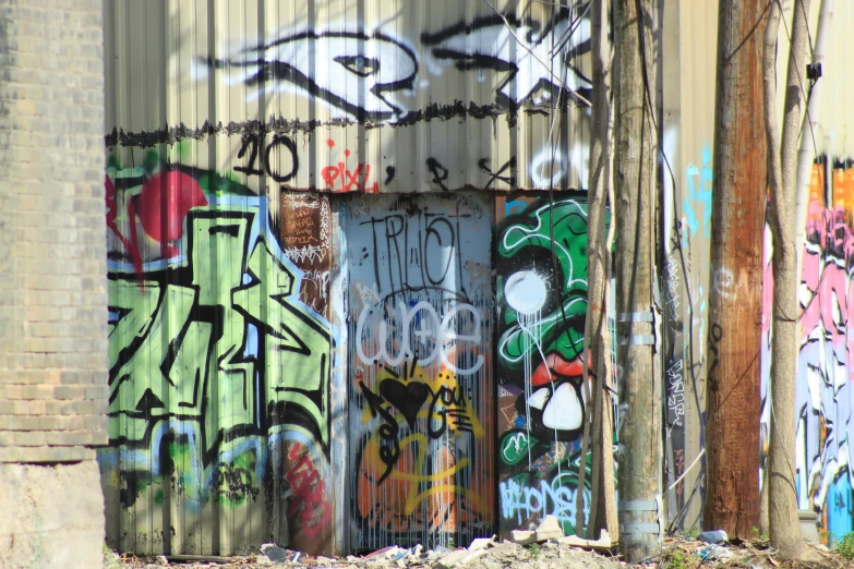 a lot of colorful graffiti sitting on the side of a building