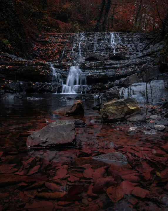 a small waterfall with a rock out side