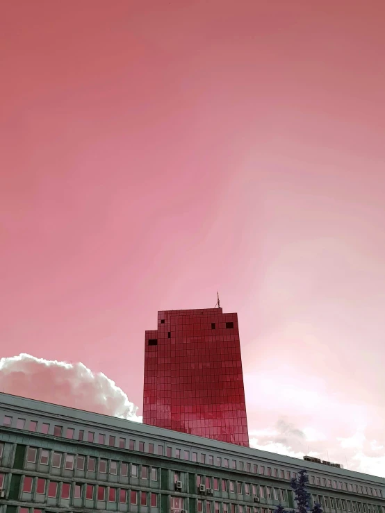 a tall building under a cloudy sky with clouds
