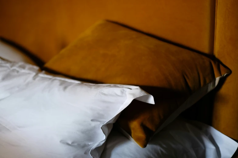 an image of a bed with white pillows and sheets