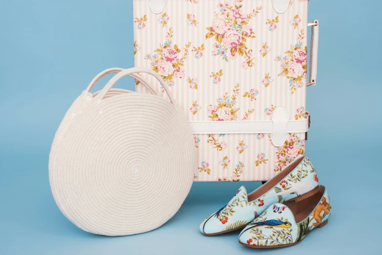 a white bag and shoes on a blue surface