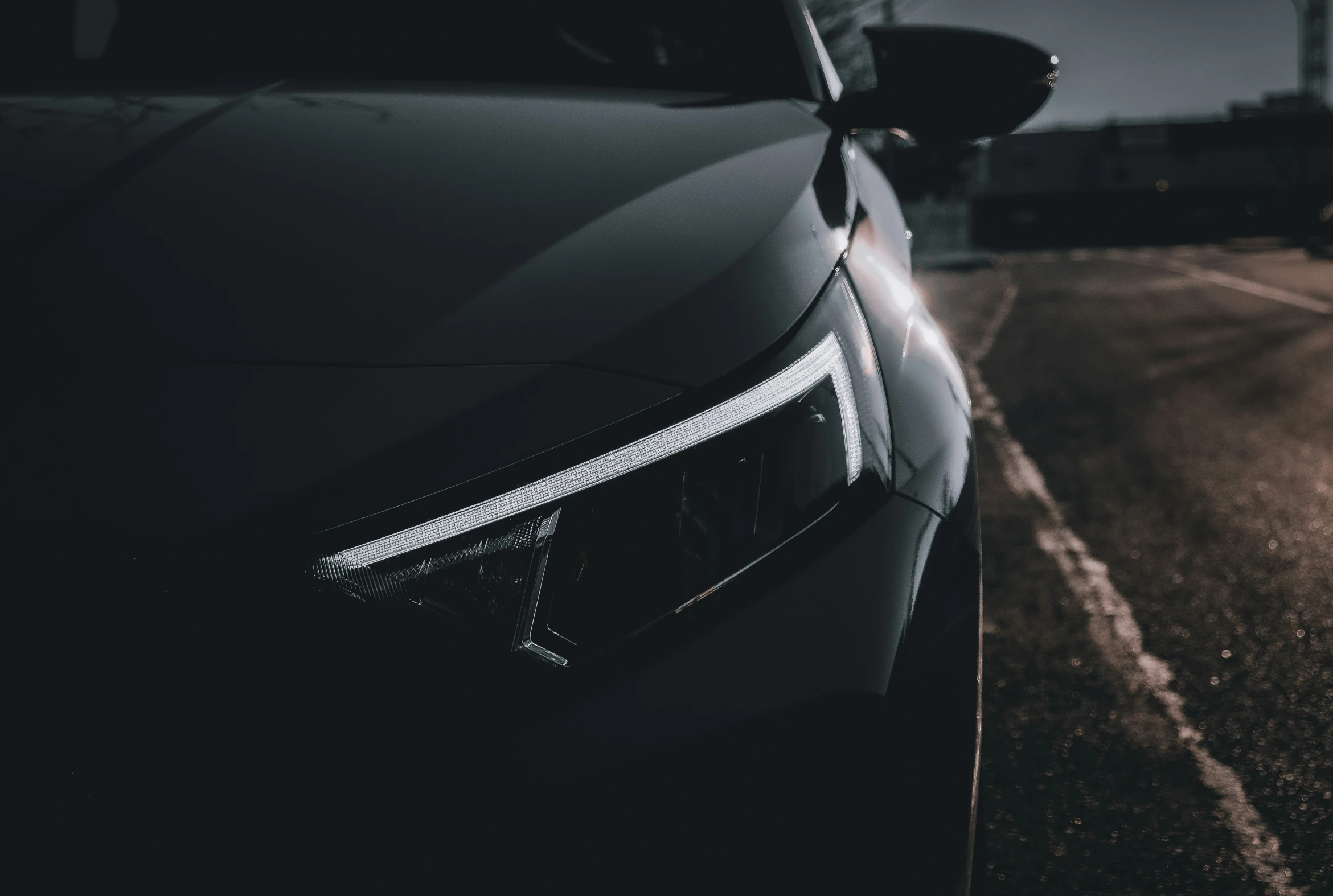 the front end of a modern, black car