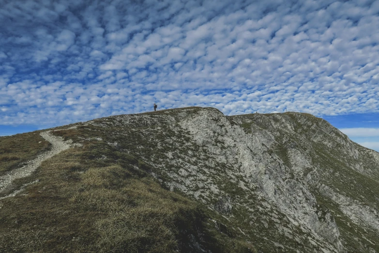 a man standing on top of a snow covered mountain