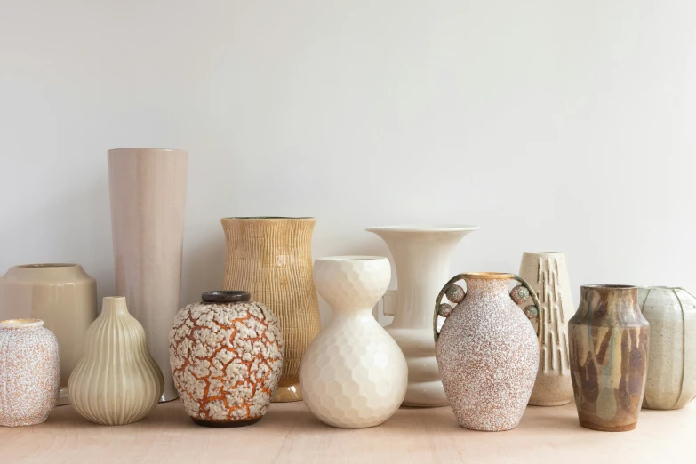 several vases and one vase is standing in a row