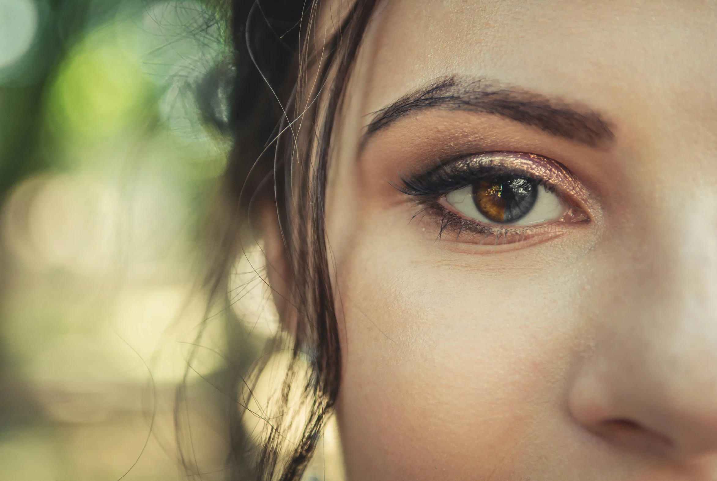 a close up of a person's face with brown eyes