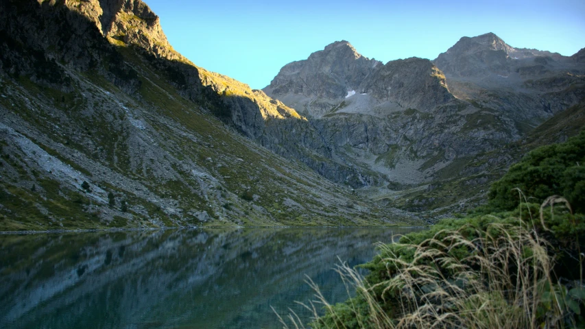 a mountain lake in the middle of a rocky cliff