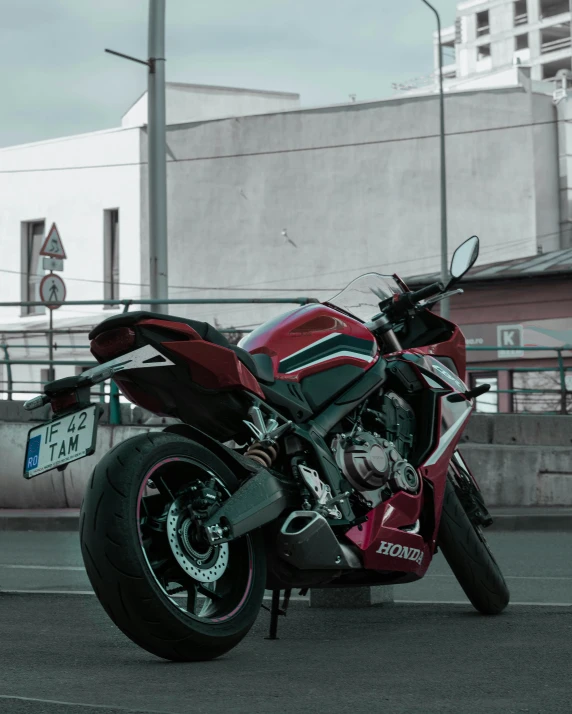 a red motorcycle parked on the side of a road