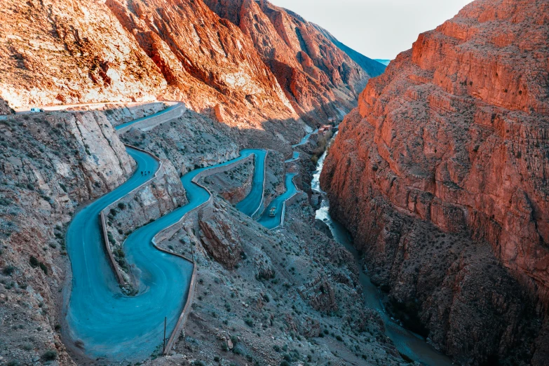 an aerial s of a winding, road near mountains