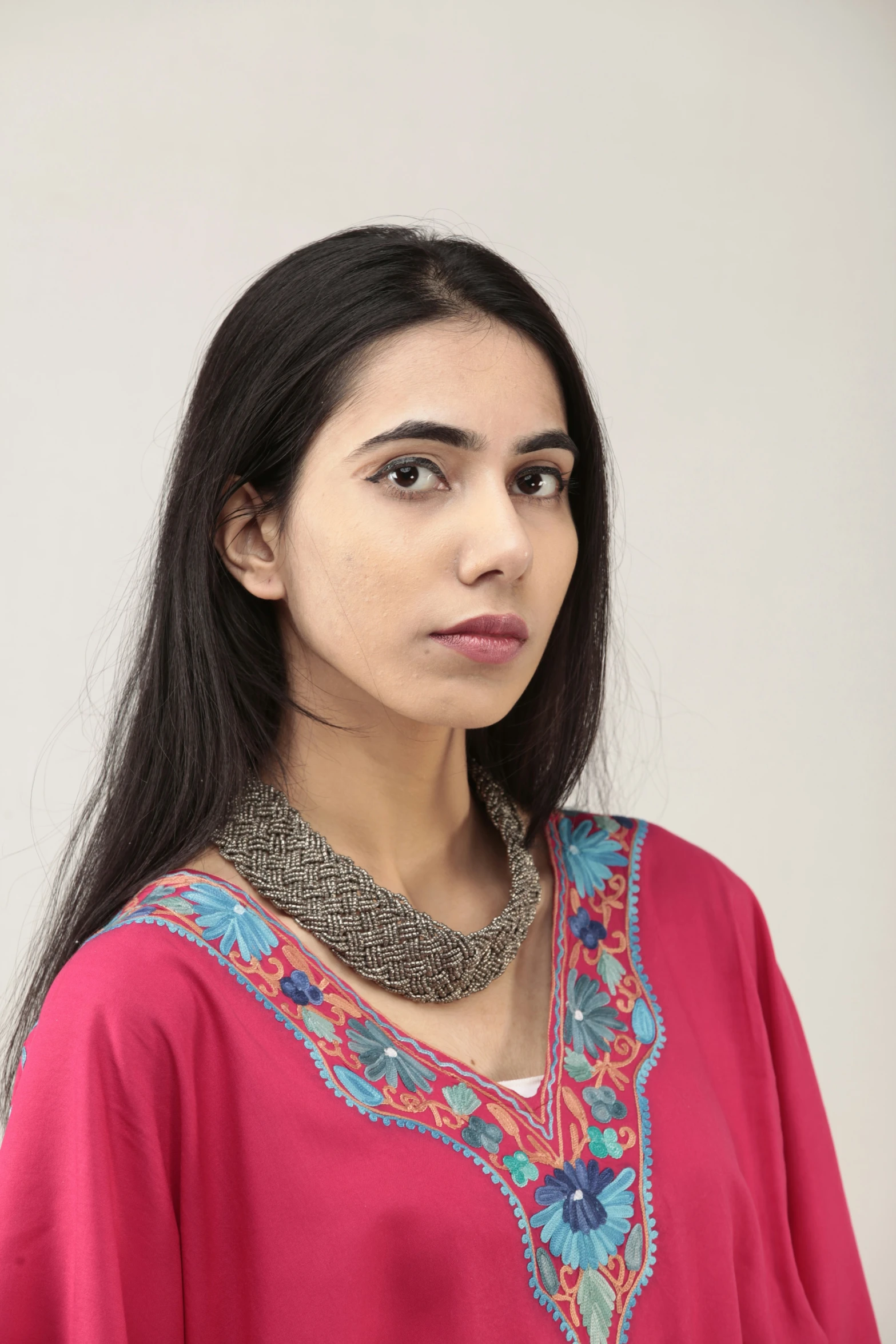 a girl is wearing a top with beaded neck and sleeves