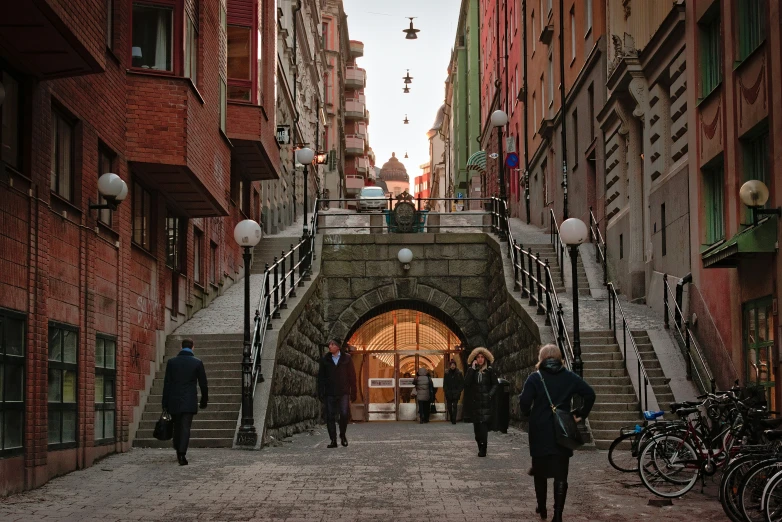 three people are walking down the steps outside a building