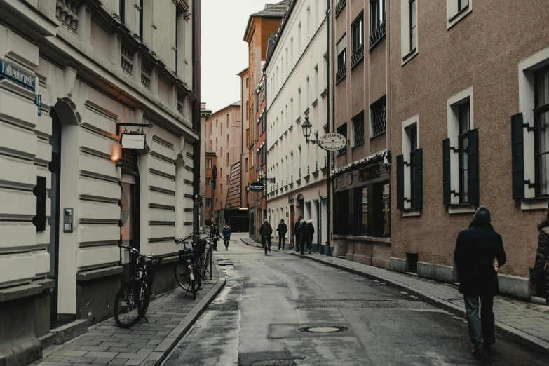 people walking on the side walk in an urban setting