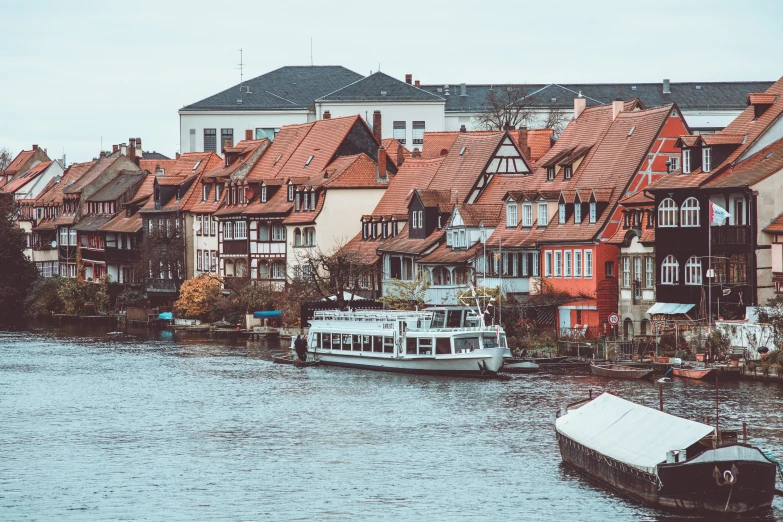 a boat sailing down the river next to buildings