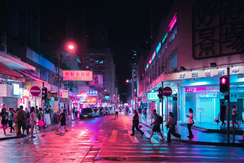 people walking across the street in front of shops