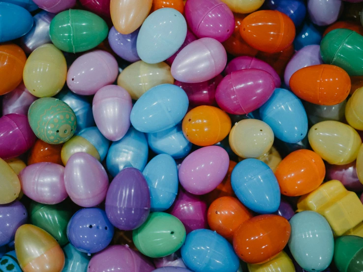 brightly colored eggs are scattered together in a mixture