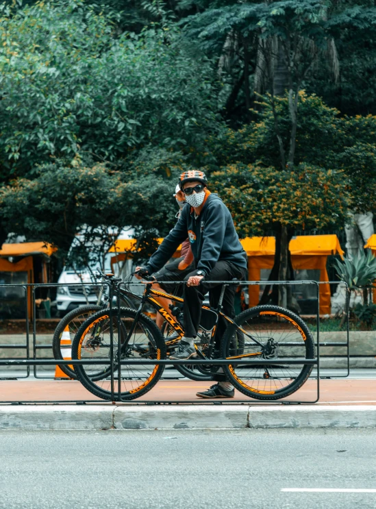 two people are riding bikes next to a rail