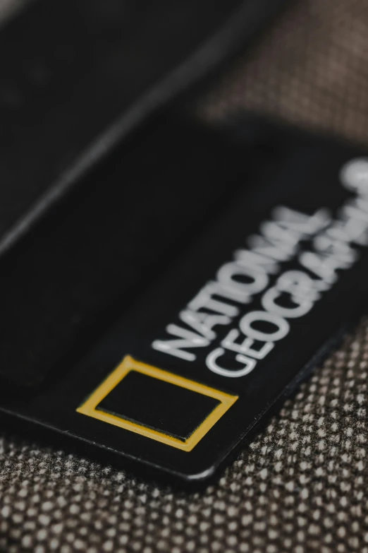a black and gold logo tag on a fabric material