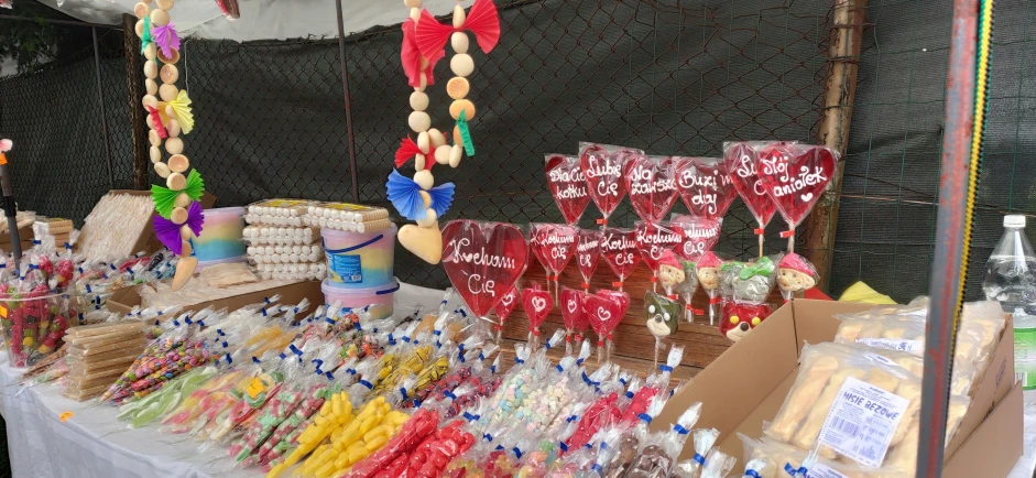 a variety of drinks and food are displayed at an outdoor event