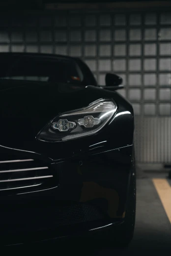 a black sports car parked inside a garage