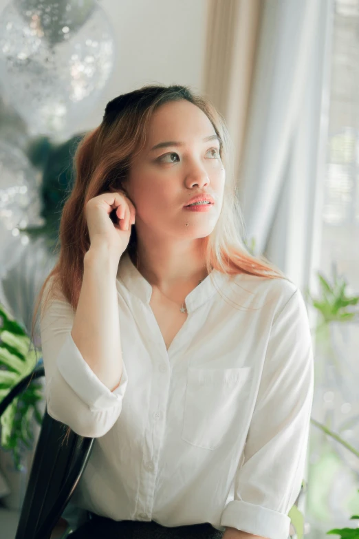 woman looking up wearing white shirt and brown skirt