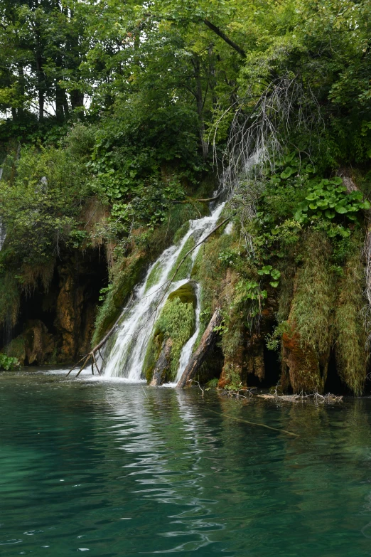 there is a waterfall with people in it