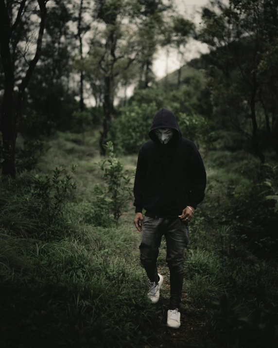 a man with an animal mask walks along a trail