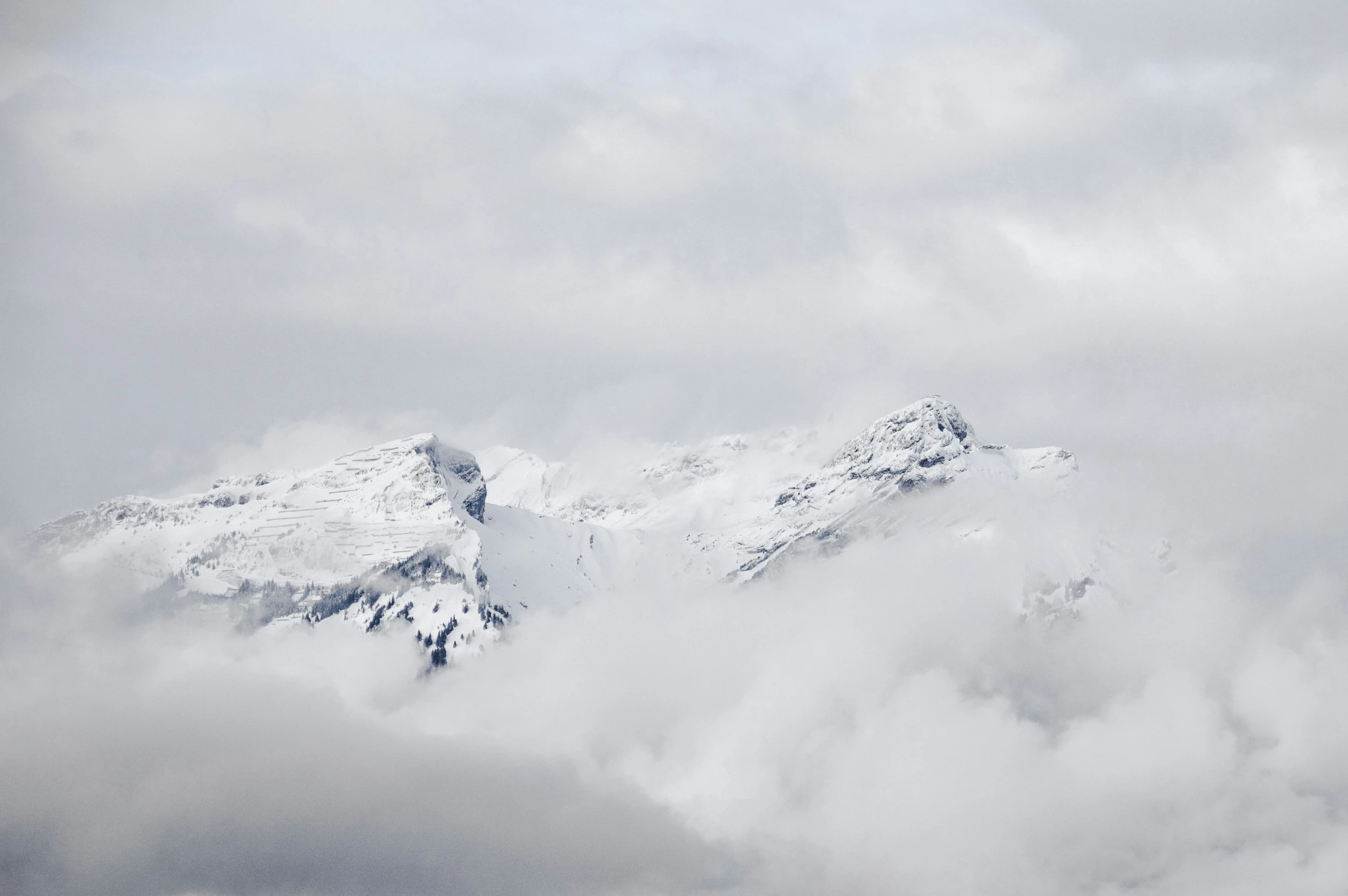 snow capped mountains are seen from the sky