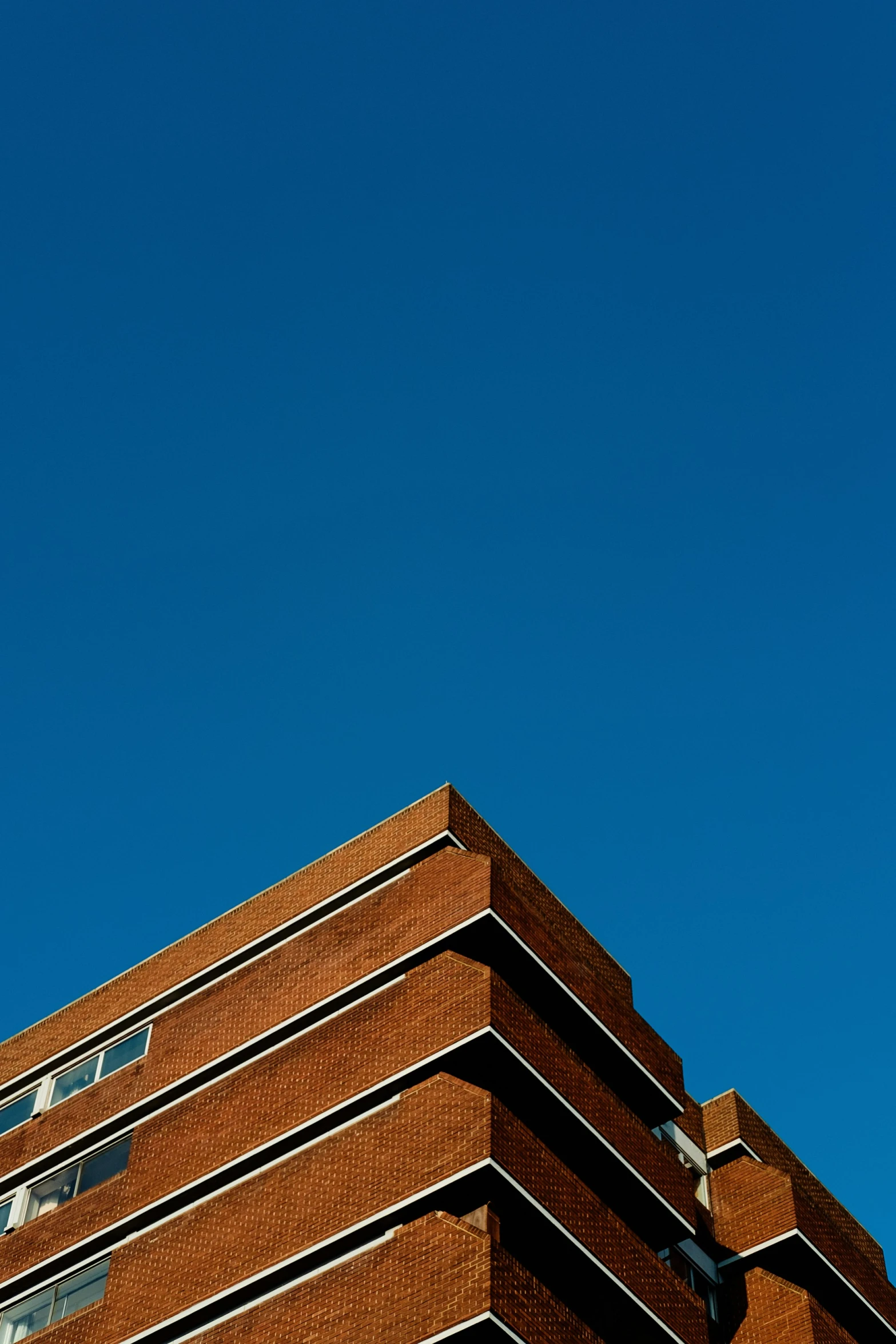 a building with a clock and a kite flying overhead