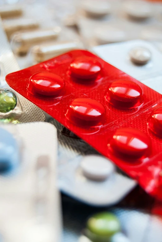 red contrapirator sitting on top of a table filled with pills