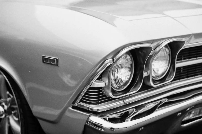 the headlights of a classic car in a black and white po
