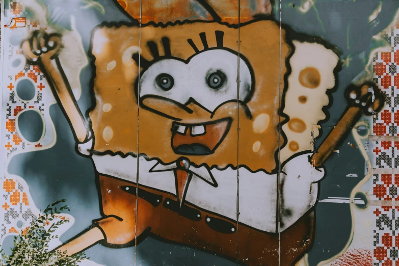 graffiti on wall depicting character from sponge bob